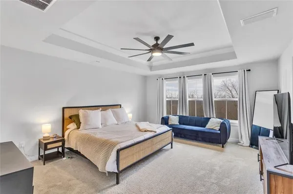 a bedroom with a bed couch and window
