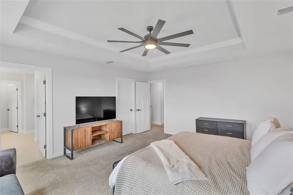a bedroom with a bed and a flat screen tv