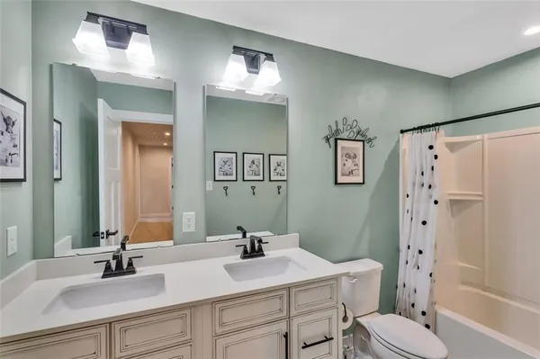 a bathroom with a sink toilet tub and shower