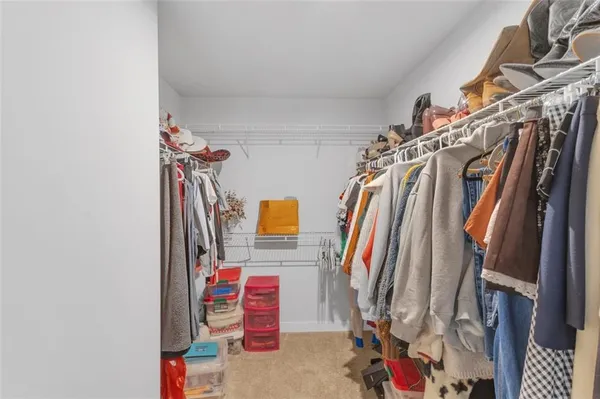 a view of walk in closet with clothes