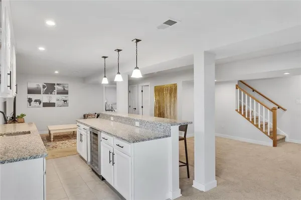 a view of a kitchen island a chandelier