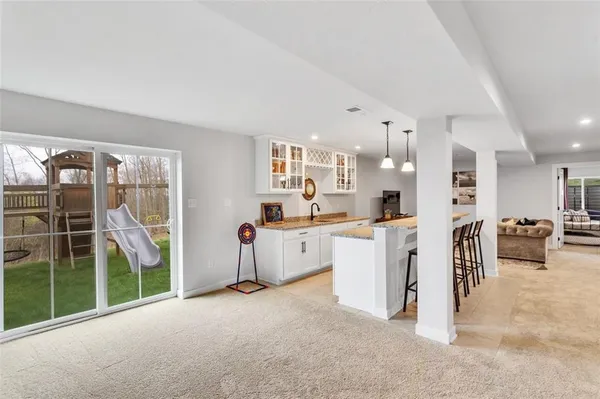 a kitchen with white cabinets and a stove