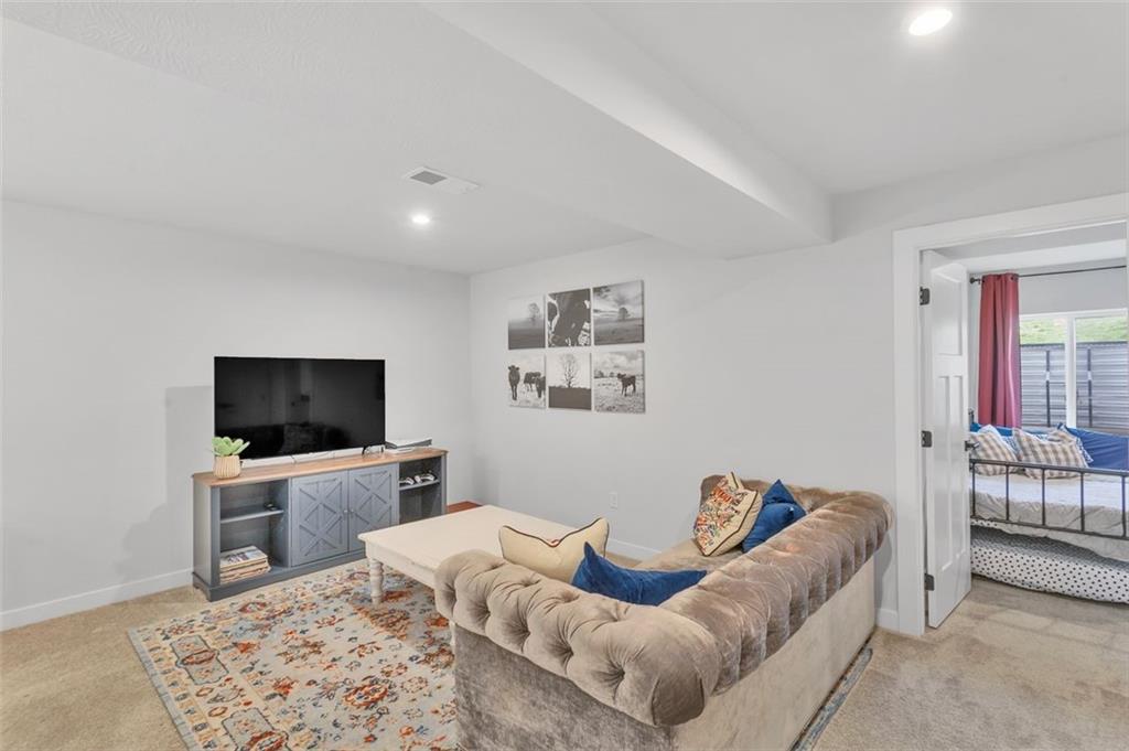 134 Woodsman Rdg Drive Harmony, PA 16037 - Photo 24 of 45 a living room with furniture and a flat screen tv