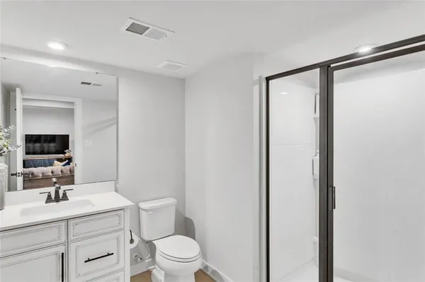 a bathroom with a sink a toilet a mirror and vanity
