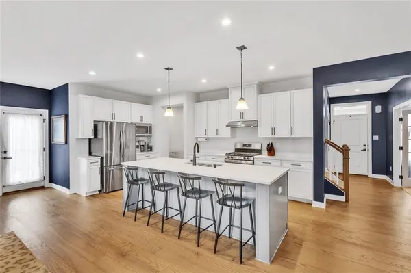 a large kitchen with a table and chairs