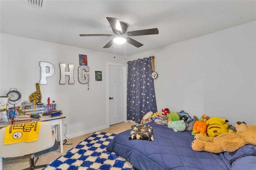 134 Woodsman Rdg Drive Harmony, PA 16037 - Photo 32 of 45 a bed room with a bed and a chandelier