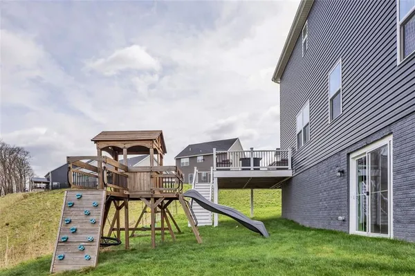 a view of a house with a big yard and potted plants