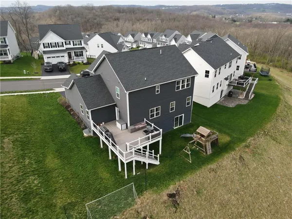 an aerial view of a house with swimming pool garden and mountain view