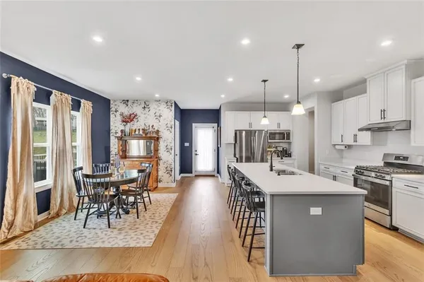 a large kitchen with a table and chairs