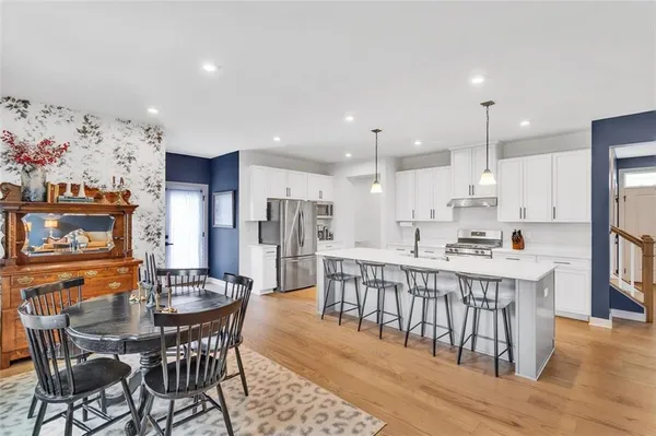 a large kitchen with a table and chairs
