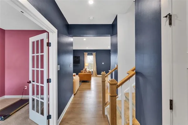 a view of a hallway with living room and furniture
