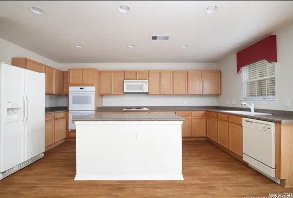 a view of a livingroom with a ceiling fan and window