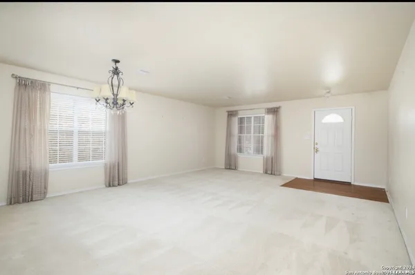 a view of a big room with closet and windows