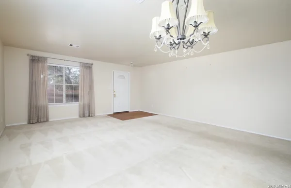 an empty room with a empty space and windows