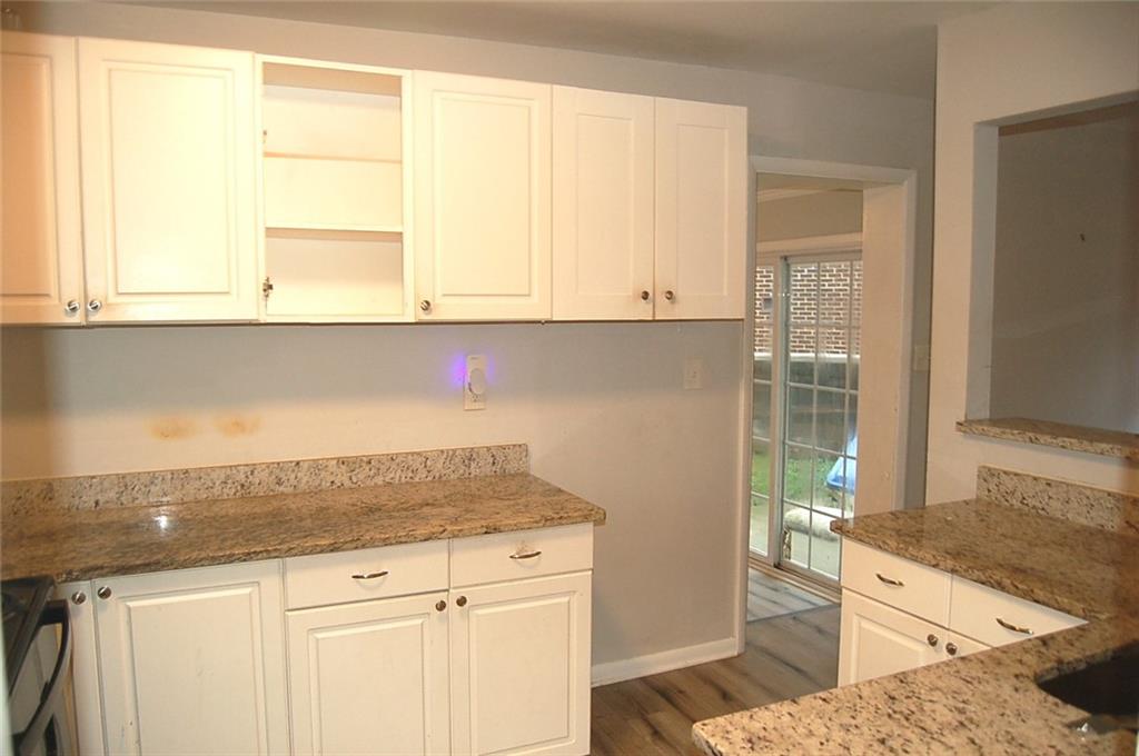 3421 Adkins Road Northwest Atlanta, GA 30331 - Photo 12 of 20 a kitchen with granite countertop white cabinets and sink