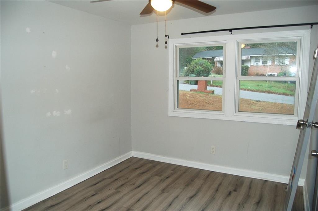 3421 Adkins Road Northwest Atlanta, GA 30331 - Photo 13 of 20 a view of an empty room with wooden floor and a window