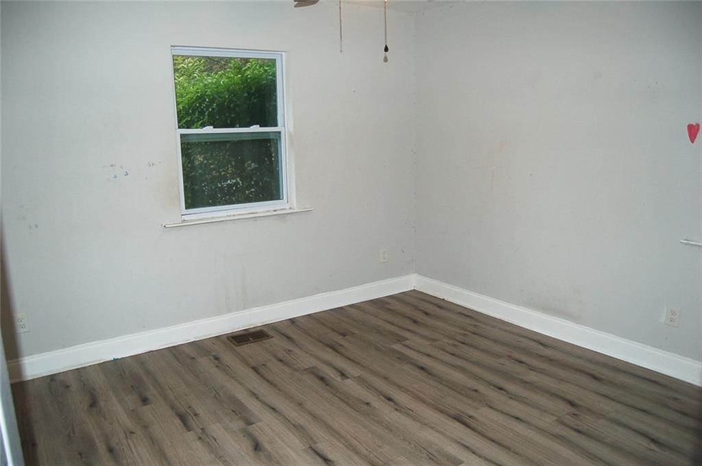 3421 Adkins Road Northwest Atlanta, GA 30331 - Photo 16 of 20 a view of an empty room with wooden floor and a window