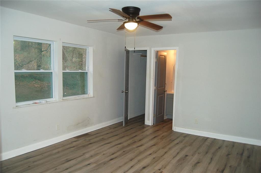 3421 Adkins Road Northwest Atlanta, GA 30331 - Photo 17 of 20 a view of empty room with wooden floor and fan