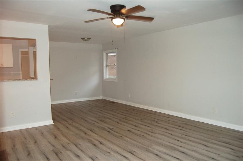 3421 Adkins Road Northwest Atlanta, GA 30331 - Photo 5 of 20 wooden floor in an empty room with a window