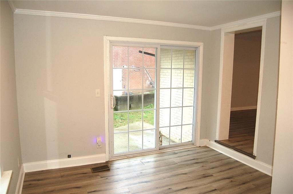 3421 Adkins Road Northwest Atlanta, GA 30331 - Photo 7 of 20 a view of an empty room with wooden floor and a window