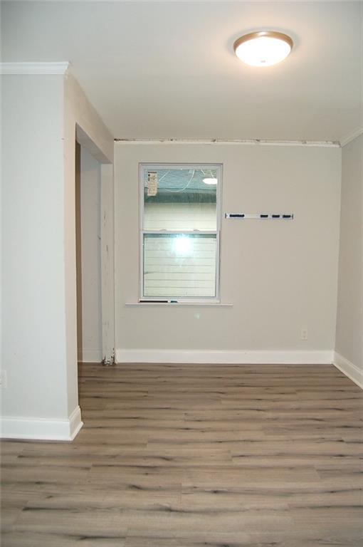 3421 Adkins Road Northwest Atlanta, GA 30331 - Photo 8 of 20 a view of an empty room with wooden floor and a window