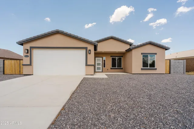 a view of a house with a yard and garage