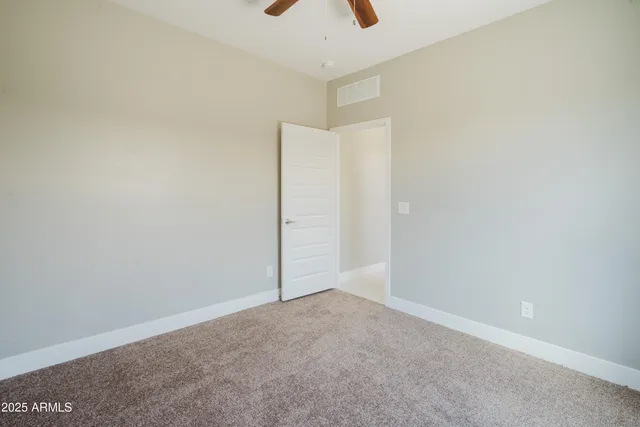 an empty room with windows and wall painting