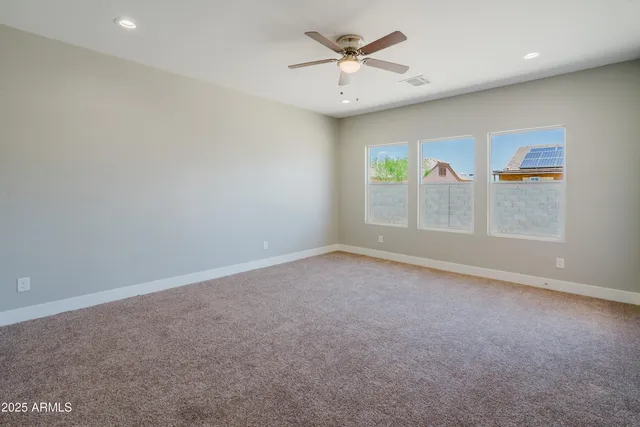 an empty room with a empty space and windows