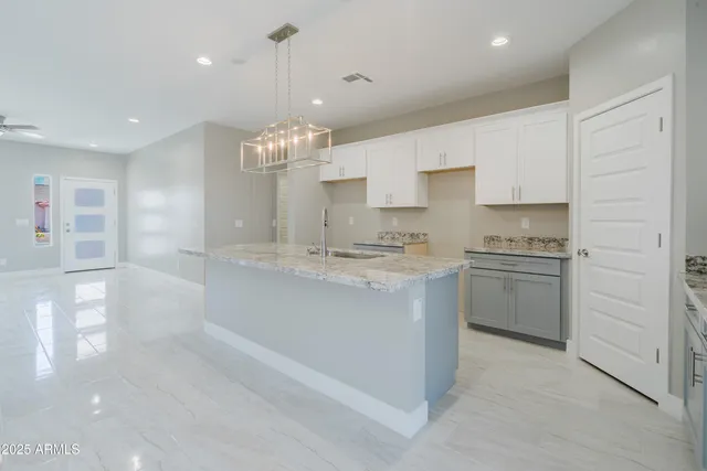 a view of a kitchen with a sink and dishwasher a refrigerator with wooden floor