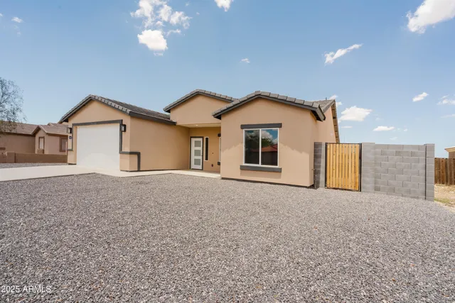 a view of a house with a yard and garage