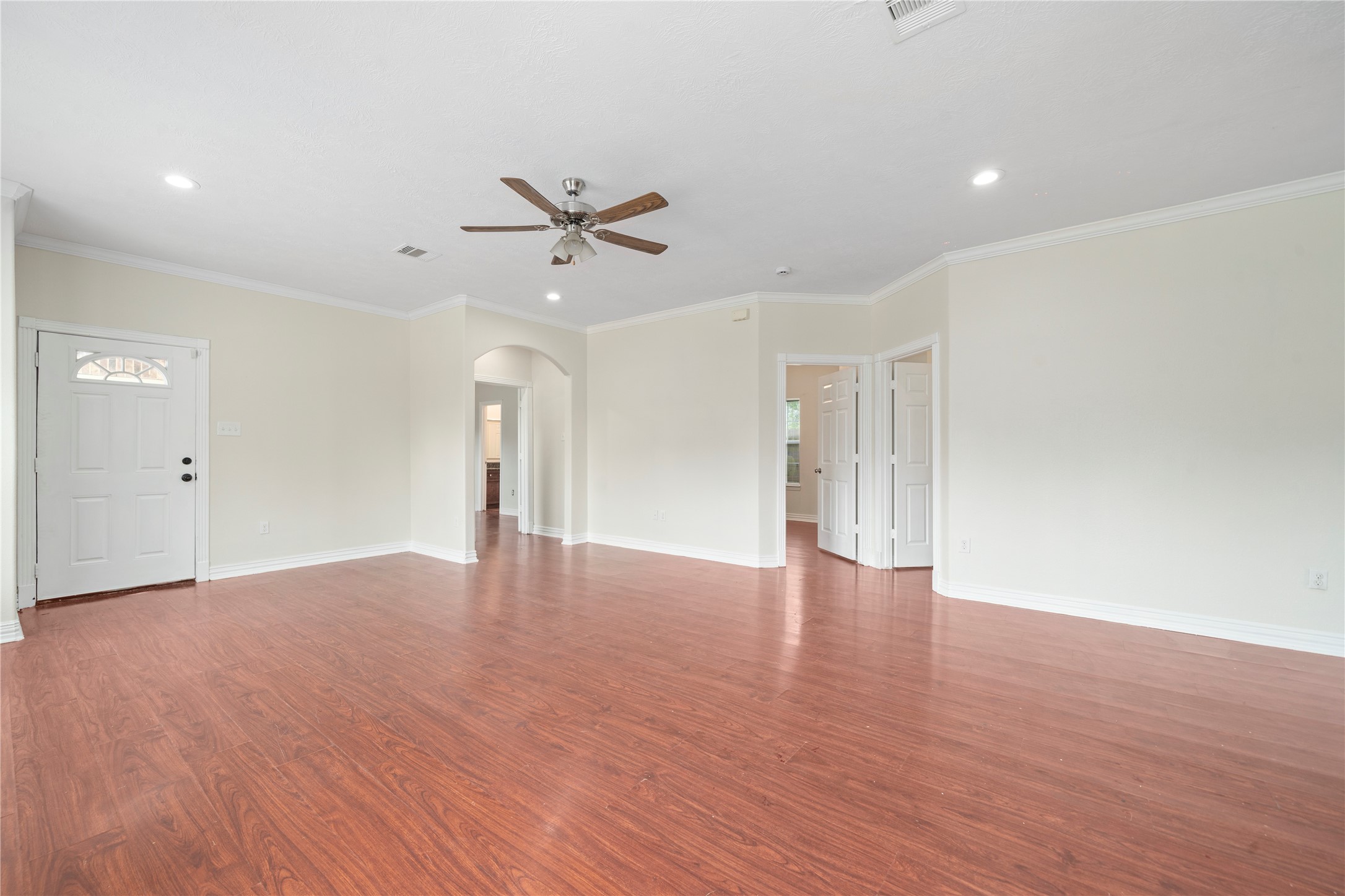 3001 Wayne Street Houston, TX 77026 - Photo 17 of 42 a view of an empty room with wooden floor and a ceiling fan