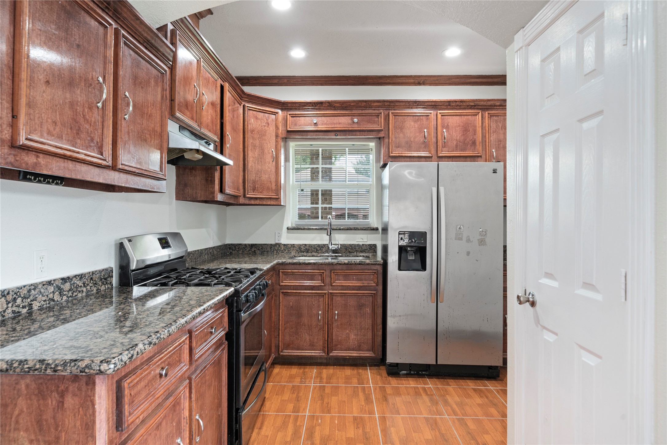 3001 Wayne Street Houston, TX 77026 - Photo 21 of 42 a kitchen with stainless steel appliances granite countertop a refrigerator stove and sink