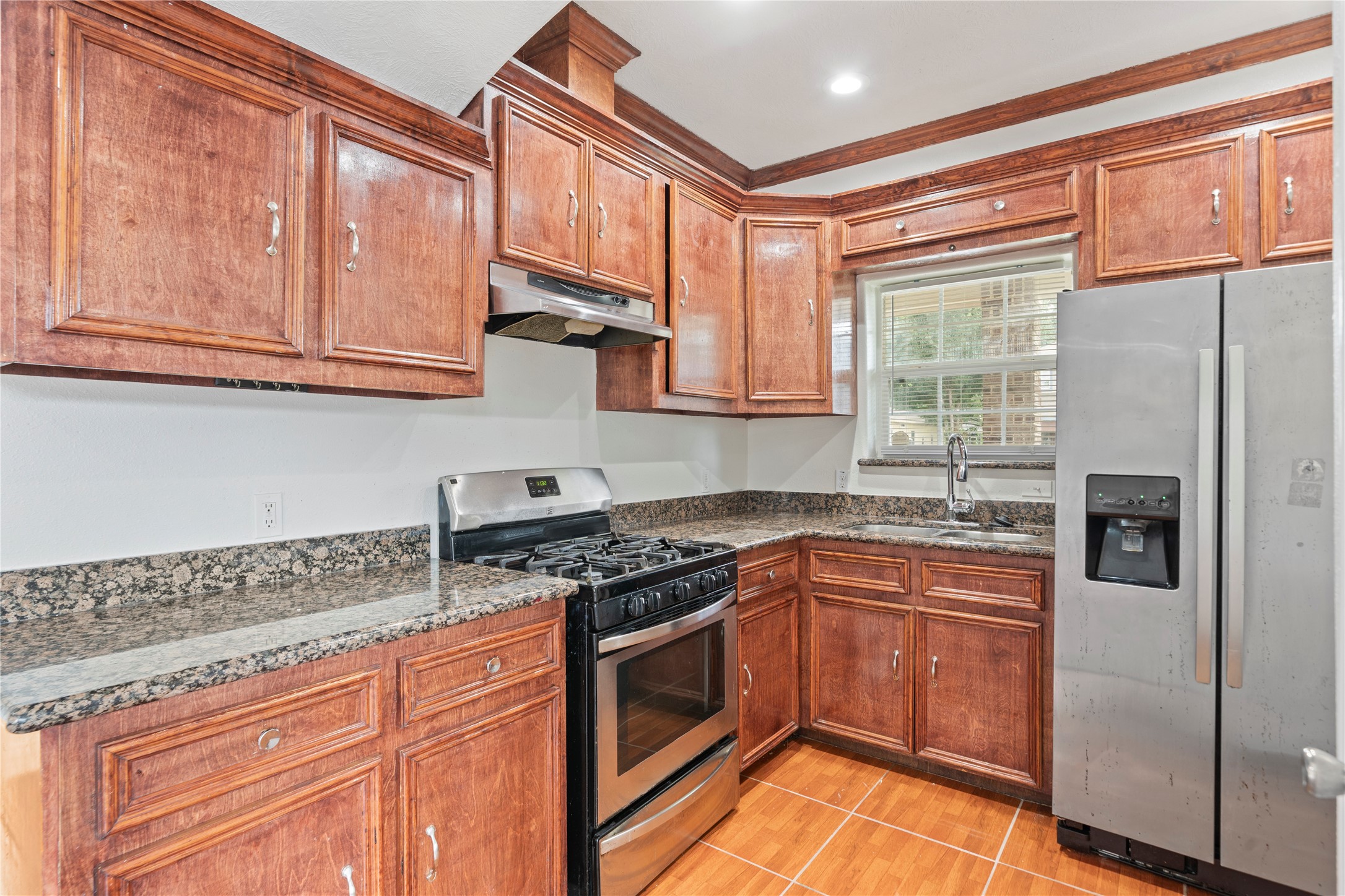 3001 Wayne Street Houston, TX 77026 - Photo 23 of 42 a kitchen with stainless steel appliances granite countertop a stove a sink and a refrigerator