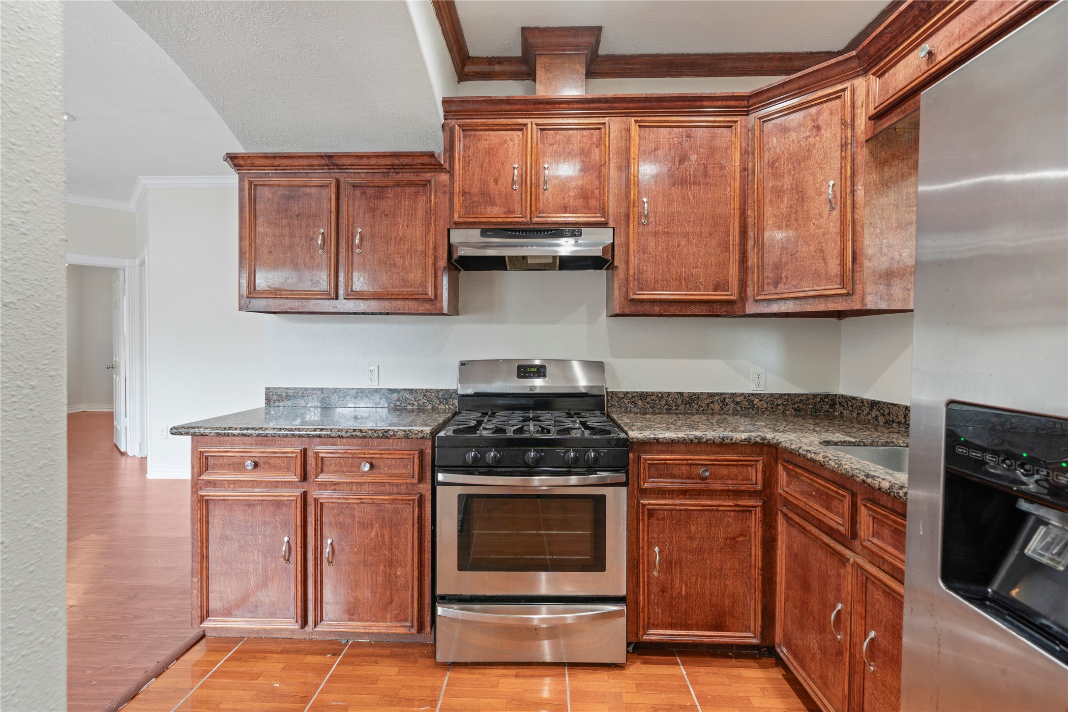 3001 Wayne Street Houston, TX 77026 - Photo 24 of 42 a kitchen with granite countertop wood cabinets and stainless steel appliances