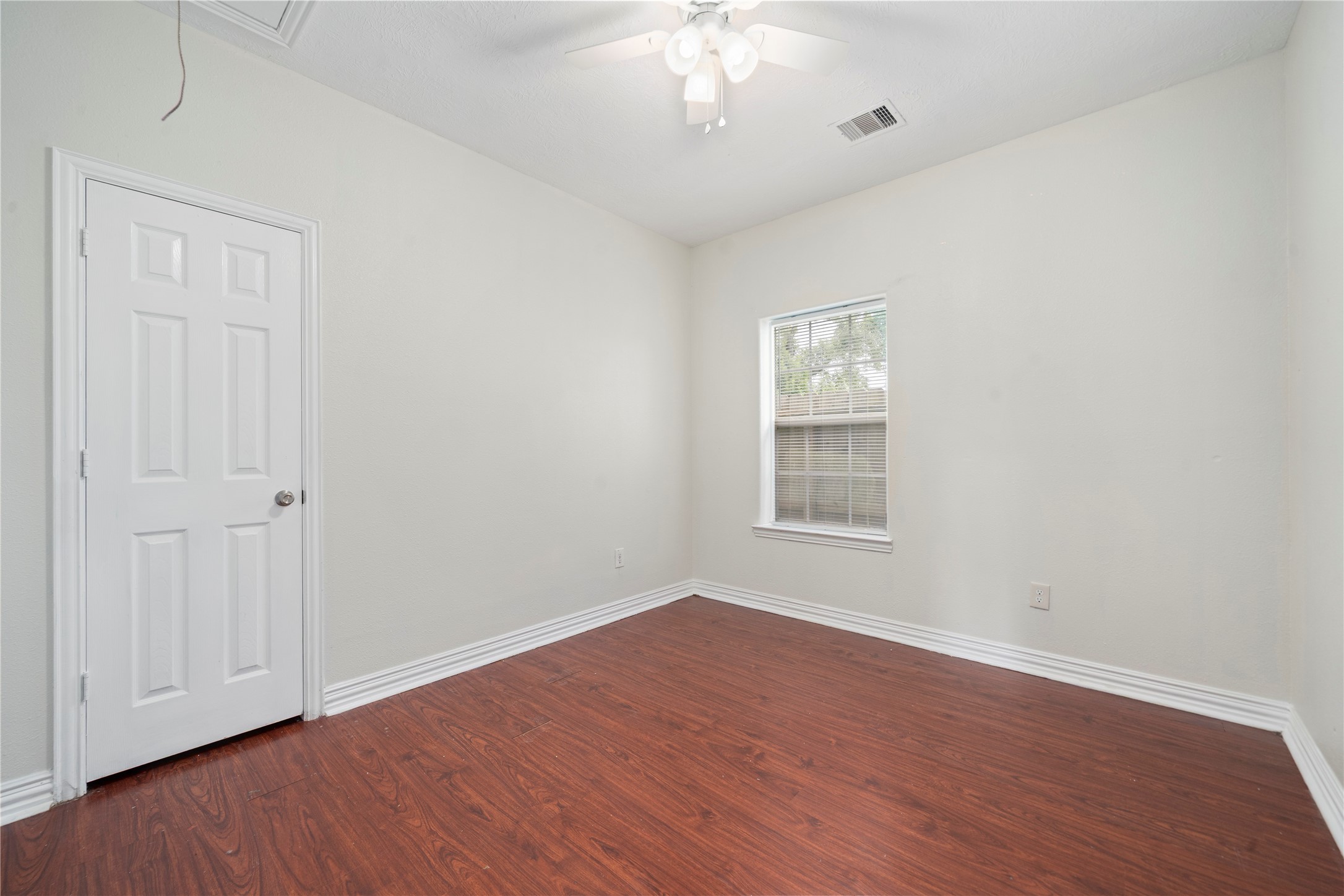 3001 Wayne Street Houston, TX 77026 - Photo 27 of 42 a view of an empty room with wooden floor and a window