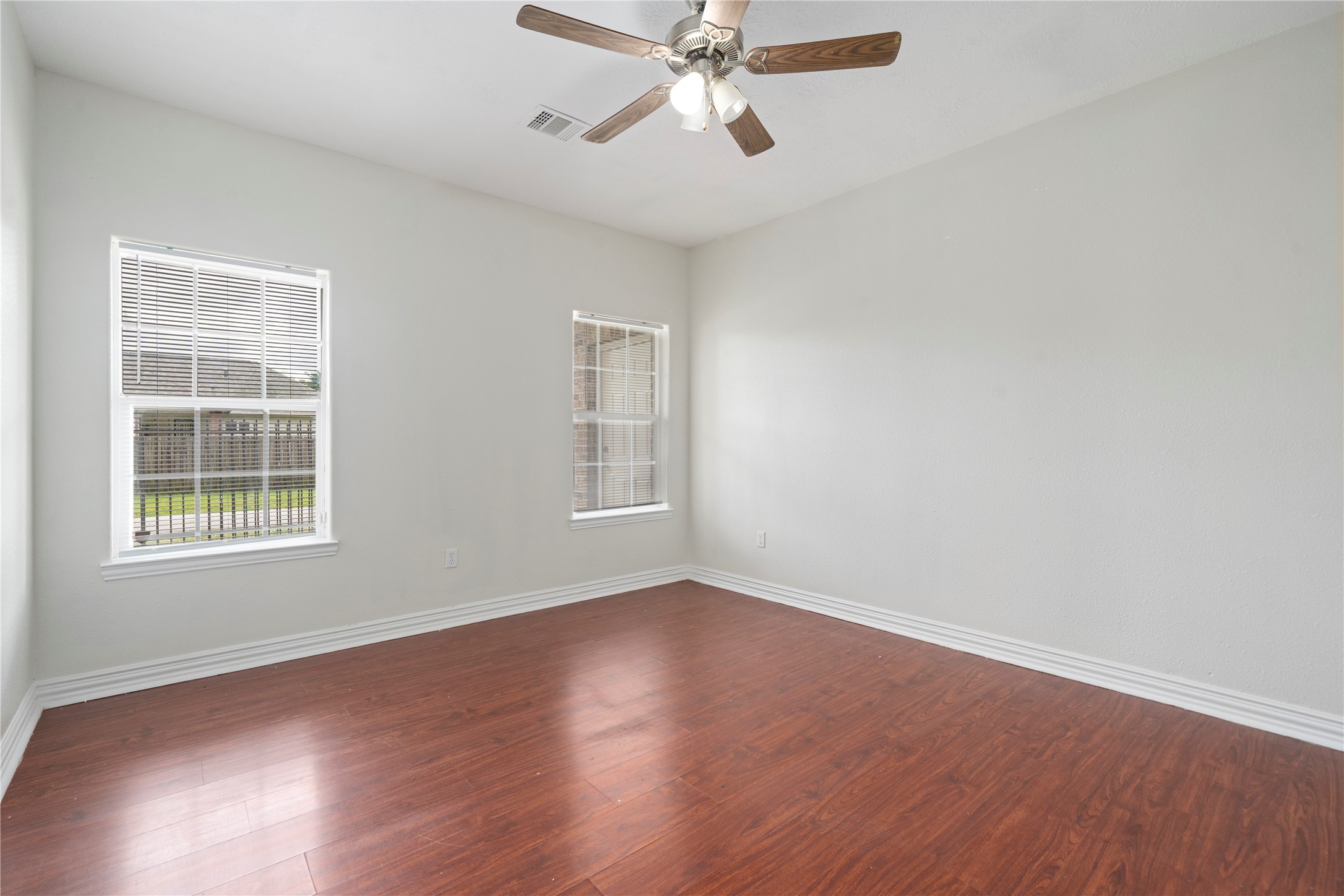 3001 Wayne Street Houston, TX 77026 - Photo 29 of 42 an empty room with wooden floor fan and windows