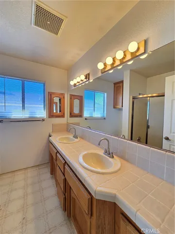 a bathroom with a sink a vanity and a mirror
