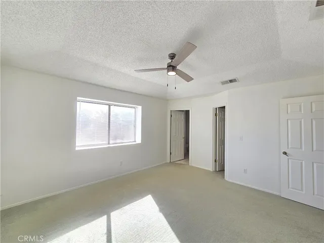 a view of a livingroom with a ceiling fan and window