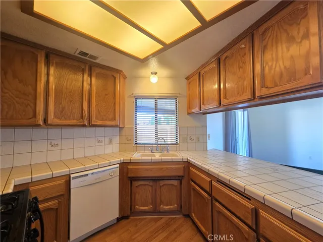 a kitchen with granite countertop cabinets stainless steel appliances and a sink