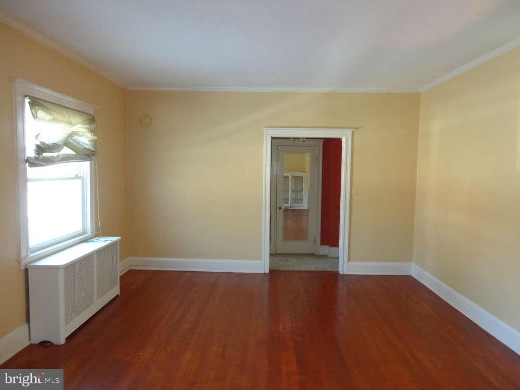 2435 Everton Road Baltimore, MD 21209 - Photo 5 of 28 an empty room with wooden floor and windows