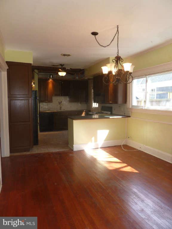 2435 Everton Road Baltimore, MD 21209 - Photo 7 of 28 a view of a living room a kitchen and a chandelier