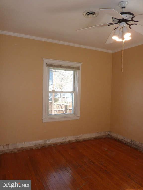 2435 Everton Road Baltimore, MD 21209 - Photo 10 of 28 an empty room with wooden floor and windows