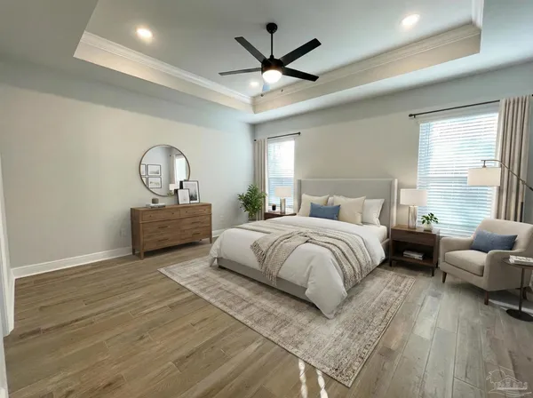 a bedroom with a bed couch chandelier and a window