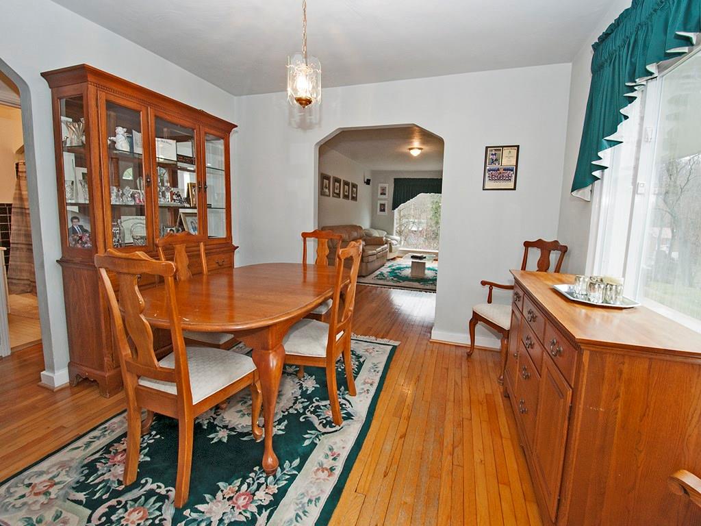 923 McNeilly Road Mt. Lebanon, PA 15226 - Photo 8 of 21 Dining Room with hardwood floors, neutral paint color, and large picture window. Notice the light that extends from the living room's oversized window.