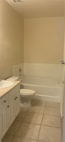 a bathroom with a toilet a sink and bathtub