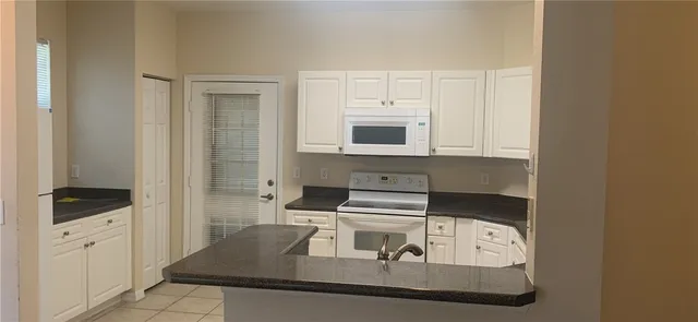 a kitchen with a stove and a microwave