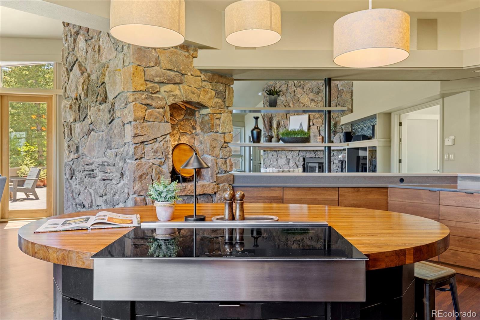 1323 South Snyder Gulch Road Evergreen, CO 80439 - Photo 12 of 47 a kitchen with a table and chairs in it