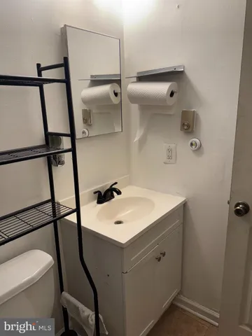 a bathroom with a sink toilet and a mirror