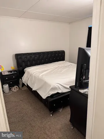 a bedroom with a bed and a television