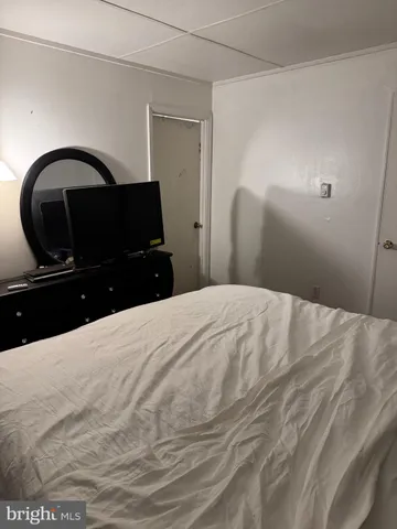 a bedroom with a bed and a large mirror